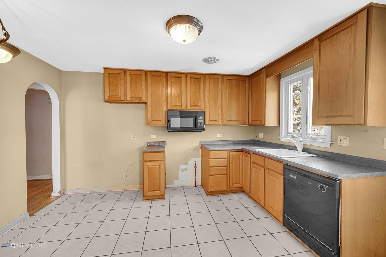 3438 Randolph Street Lansing, IL 60438 - Photo 13 of 23 a kitchen with a sink cabinets and window
