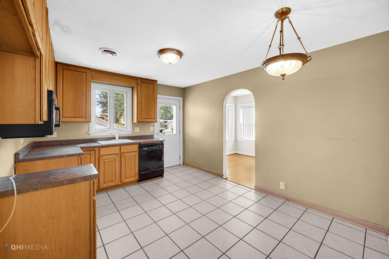 3438 Randolph Street Lansing, IL 60438 - Photo 14 of 23 a kitchen with a sink a counter top space cabinets and stainless steel appliances