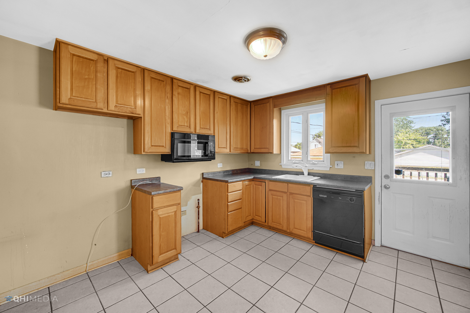 3438 Randolph Street Lansing, IL 60438 - Photo 15 of 23 a kitchen with a sink cabinets and window