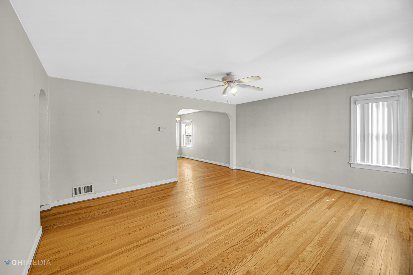 3438 Randolph Street Lansing, IL 60438 - Photo 7 of 23 a view of an empty room with wooden floor and a window