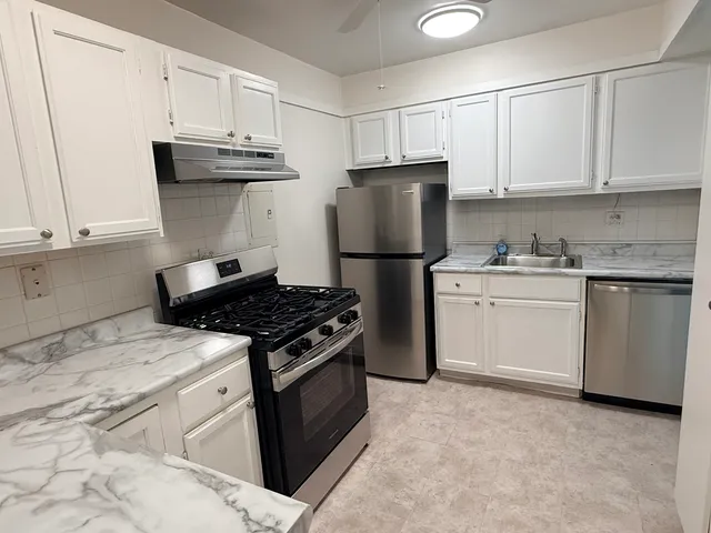 a kitchen with a stove and a refrigerator