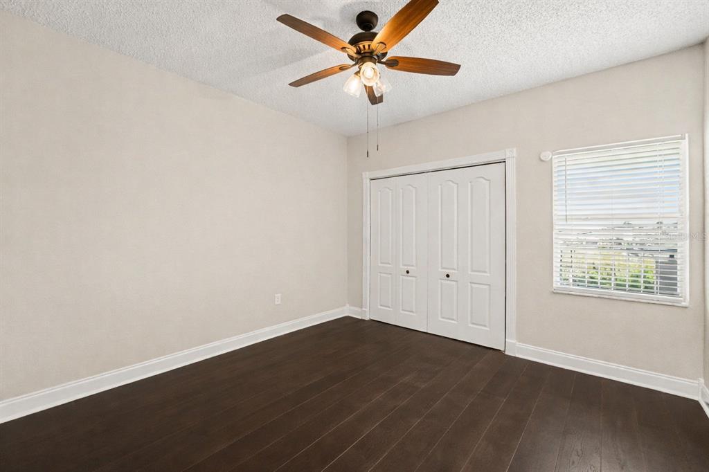 5567 Sea Forest Drive, Unit 324 New Port Richey, FL 34652 - Photo 12 of 23 wooden floor in an empty room with a window