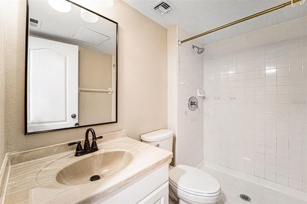5567 Sea Forest Drive, Unit 324 New Port Richey, FL 34652 - Photo 13 of 23 a bathroom with a sink toilet and shower