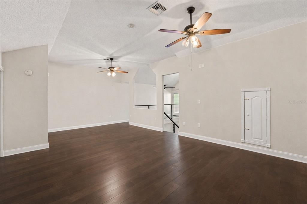 5567 Sea Forest Drive, Unit 324 New Port Richey, FL 34652 - Photo 14 of 23 wooden floor in an empty room with a window