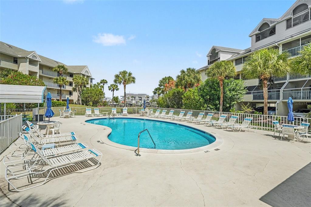 5567 Sea Forest Drive, Unit 324 New Port Richey, FL 34652 - Photo 22 of 23 a view of a swimming pool with a patio