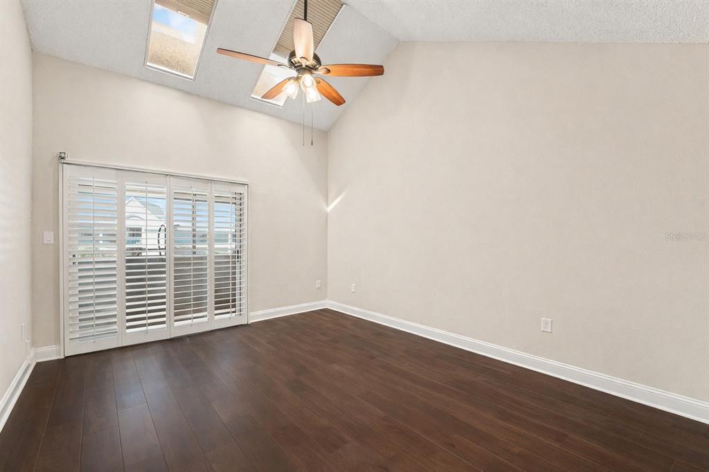 5567 Sea Forest Drive, Unit 324 New Port Richey, FL 34652 - Photo 8 of 23 an empty room with wooden floor and windows
