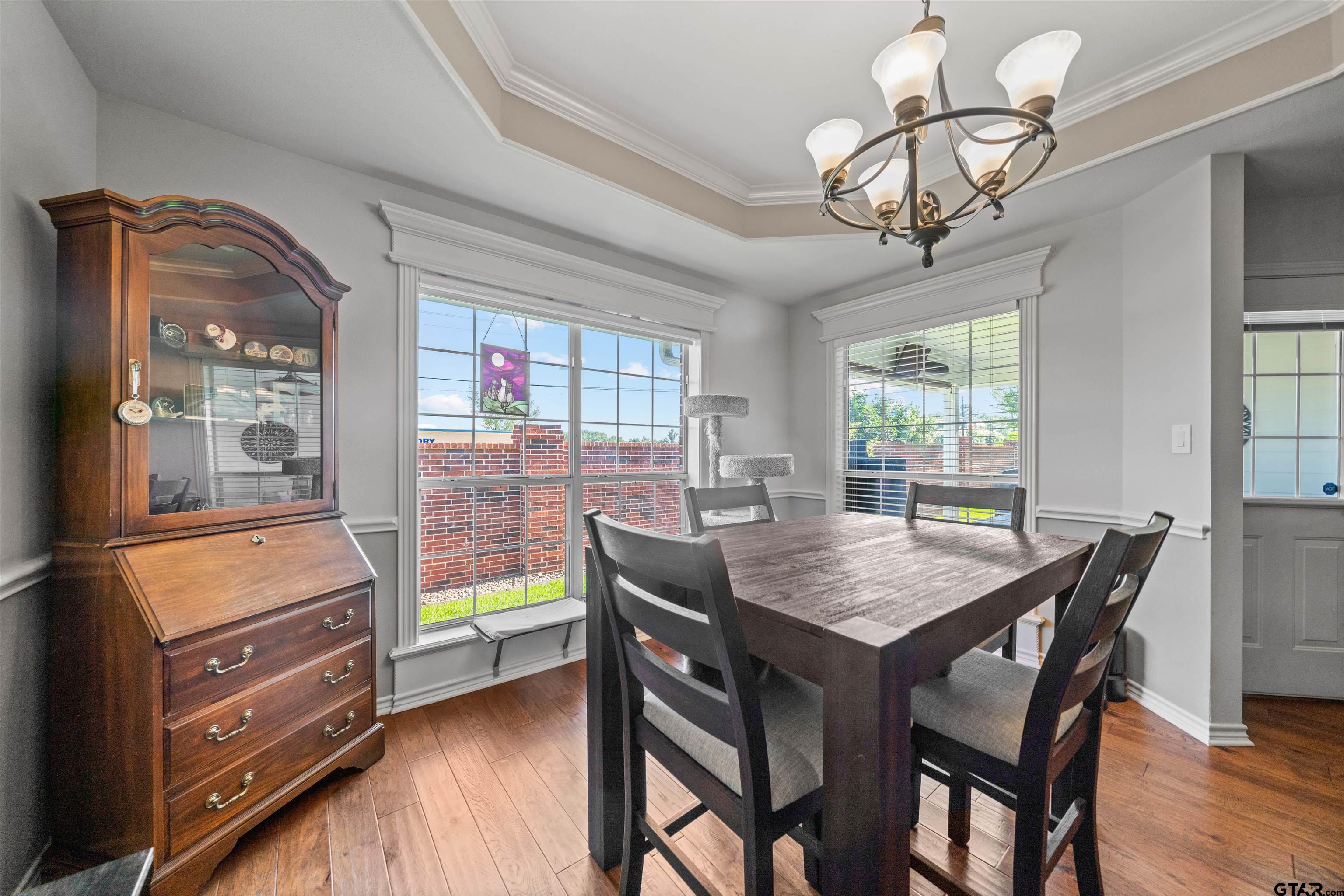 1521 Rice Road, Unit A105 Tyler, TX 75703 - Photo 14 of 28 a view of a dining room with furniture window and wooden floor