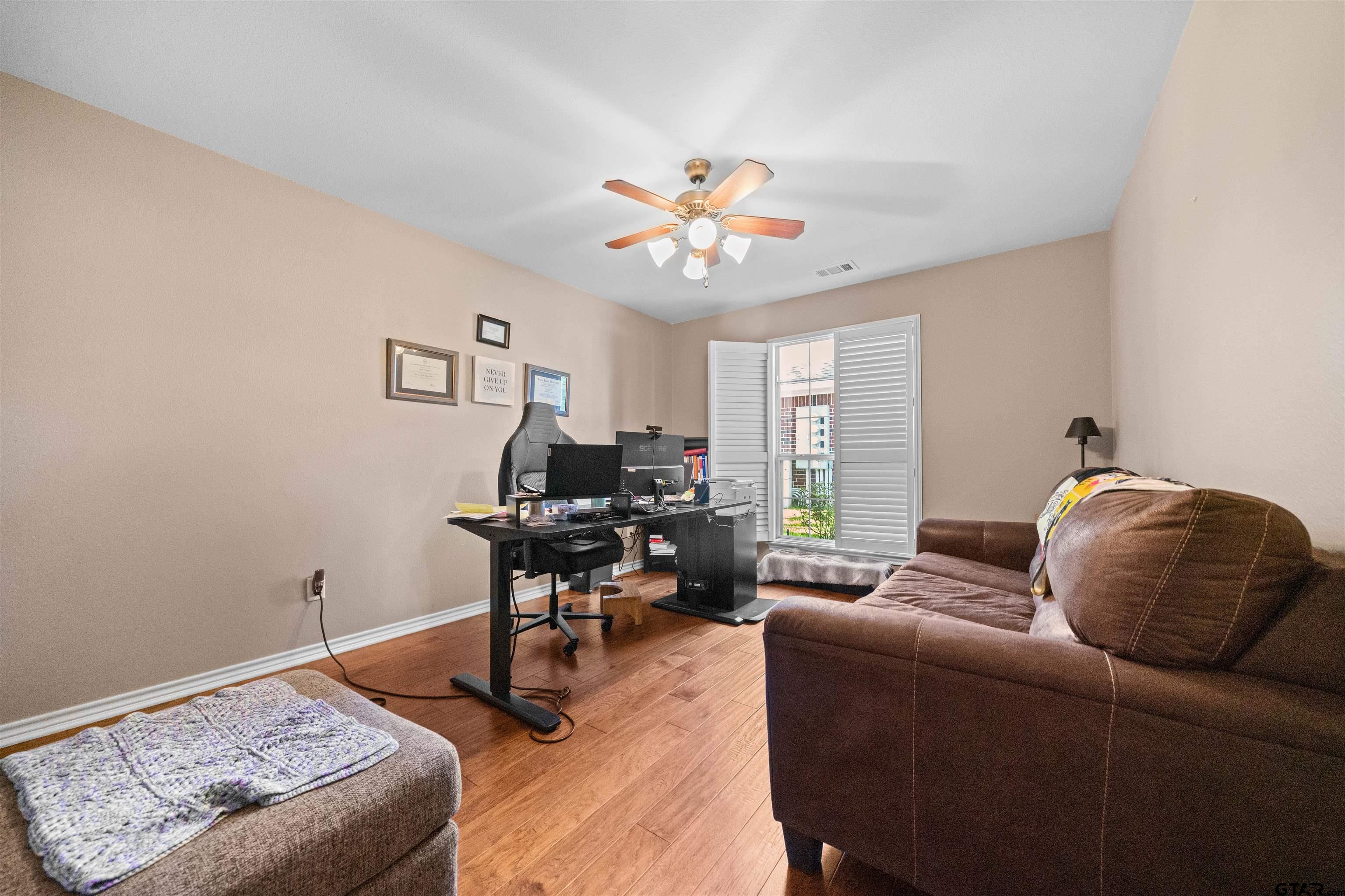 1521 Rice Road, Unit A105 Tyler, TX 75703 - Photo 18 of 28 a living room with furniture and a window