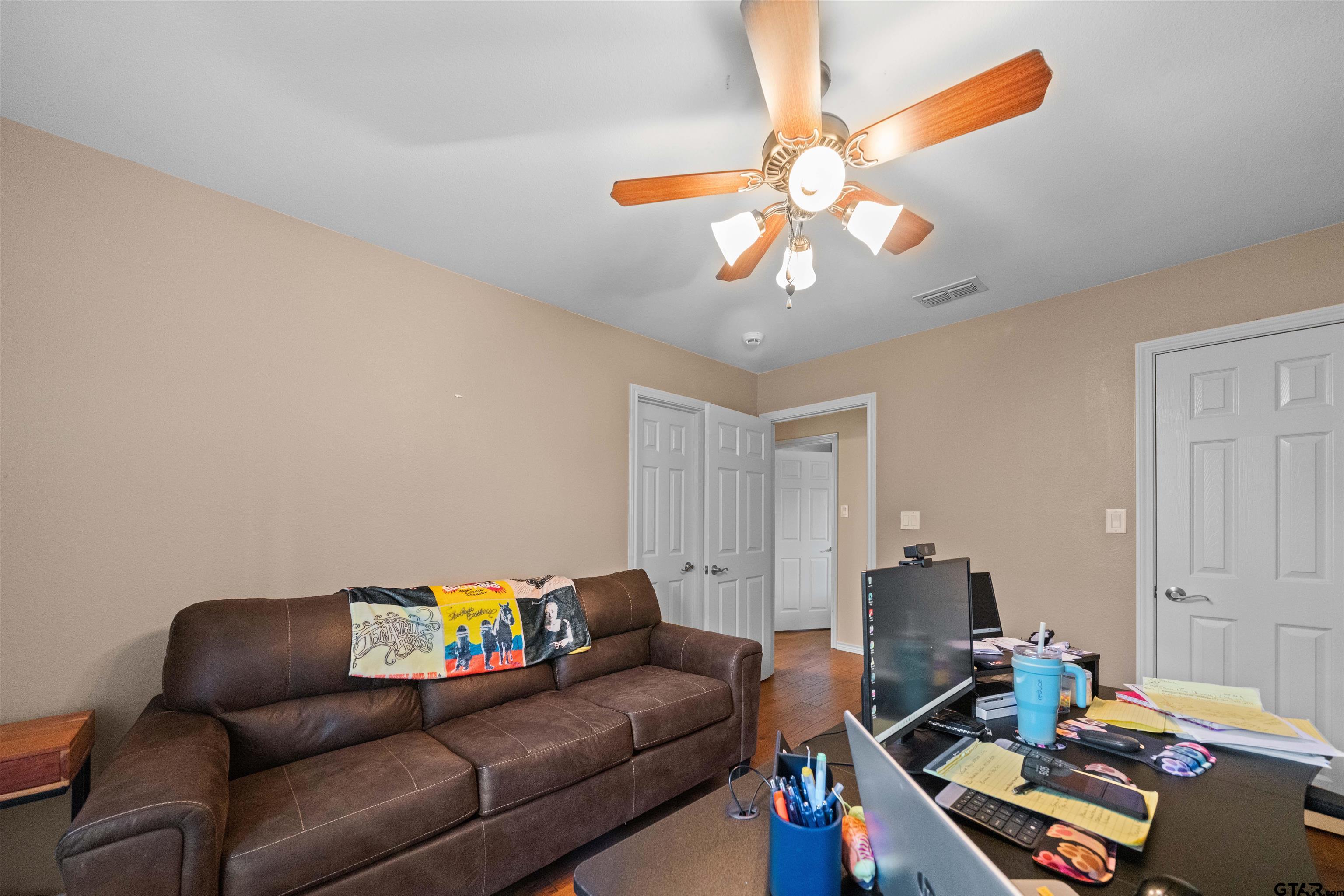 1521 Rice Road, Unit A105 Tyler, TX 75703 - Photo 19 of 28 a living room with furniture and a chandelier