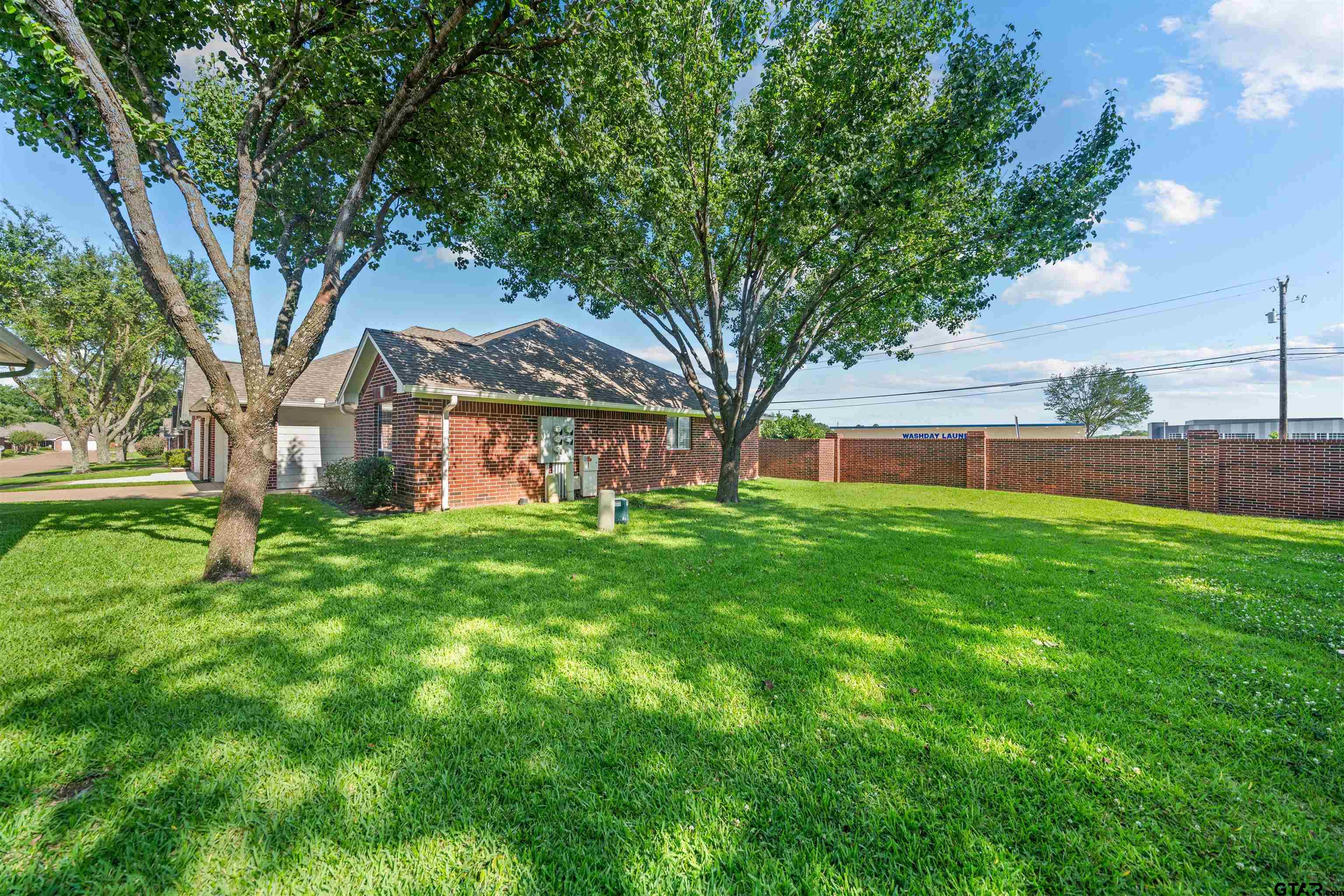 1521 Rice Road, Unit A105 Tyler, TX 75703 - Photo 2 of 28 a view of a house with a backyard