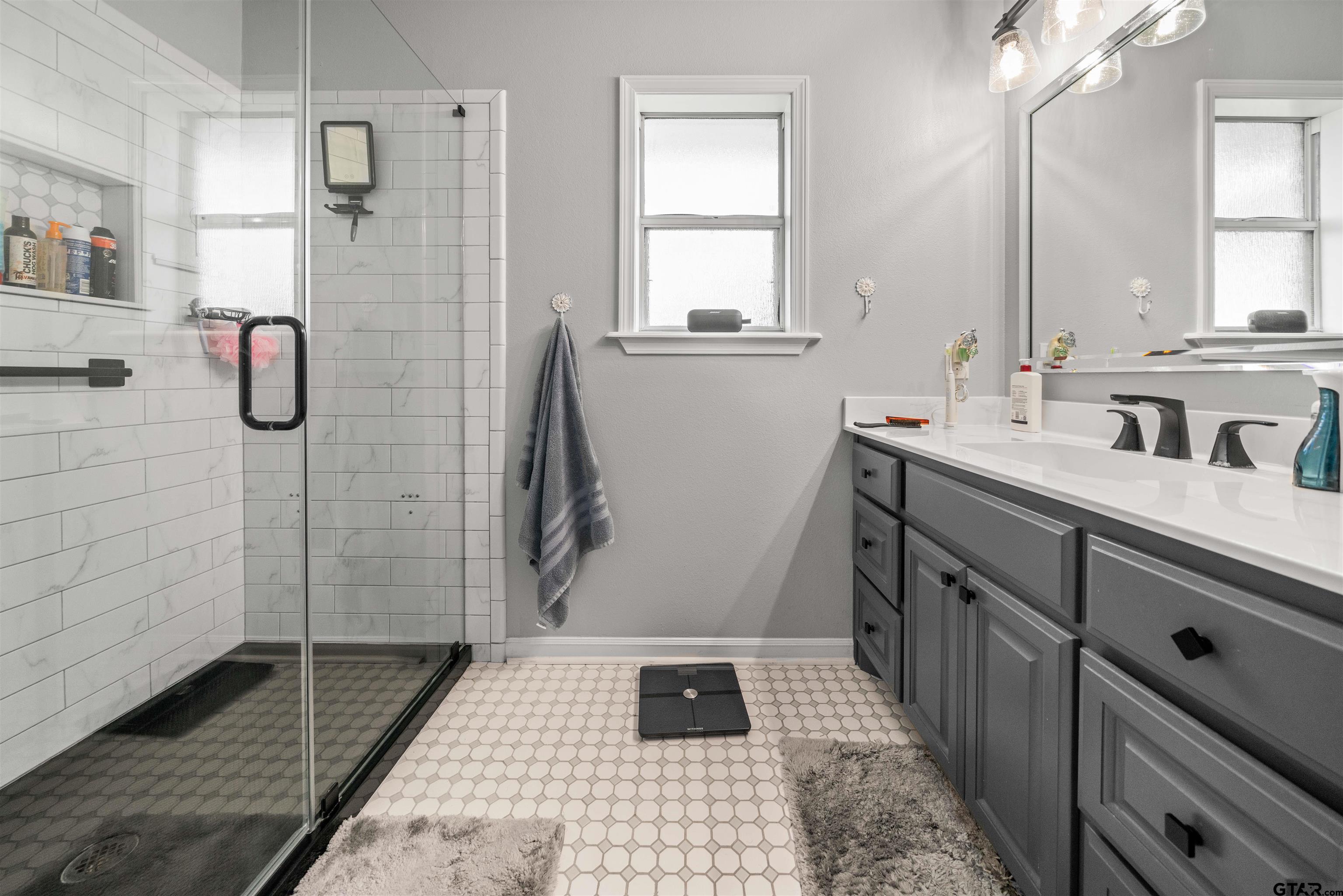 1521 Rice Road, Unit A105 Tyler, TX 75703 - Photo 23 of 28 a bathroom with a sink a toilet and shower