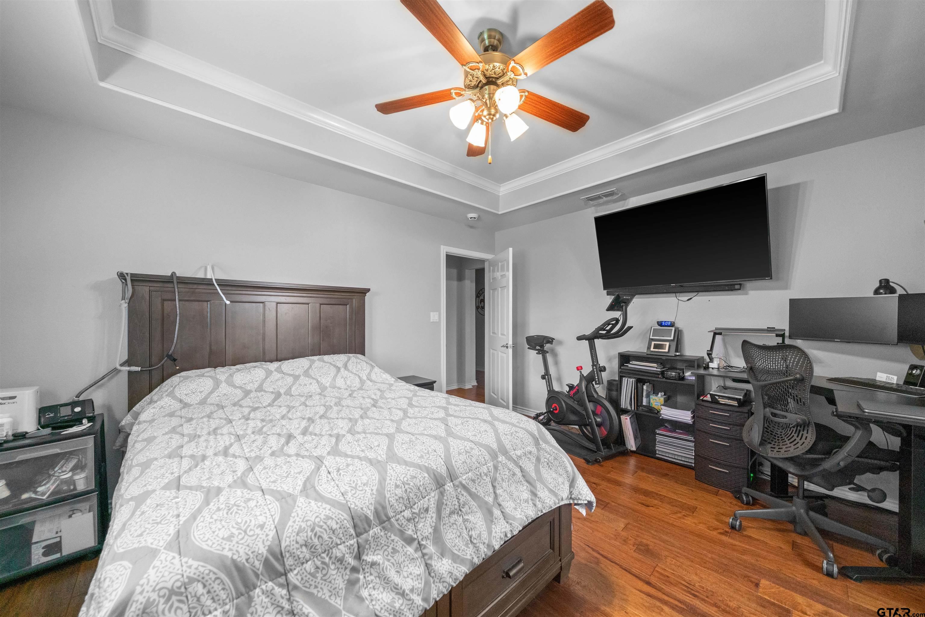 1521 Rice Road, Unit A105 Tyler, TX 75703 - Photo 26 of 28 a bedroom with a bed and a flat screen tv