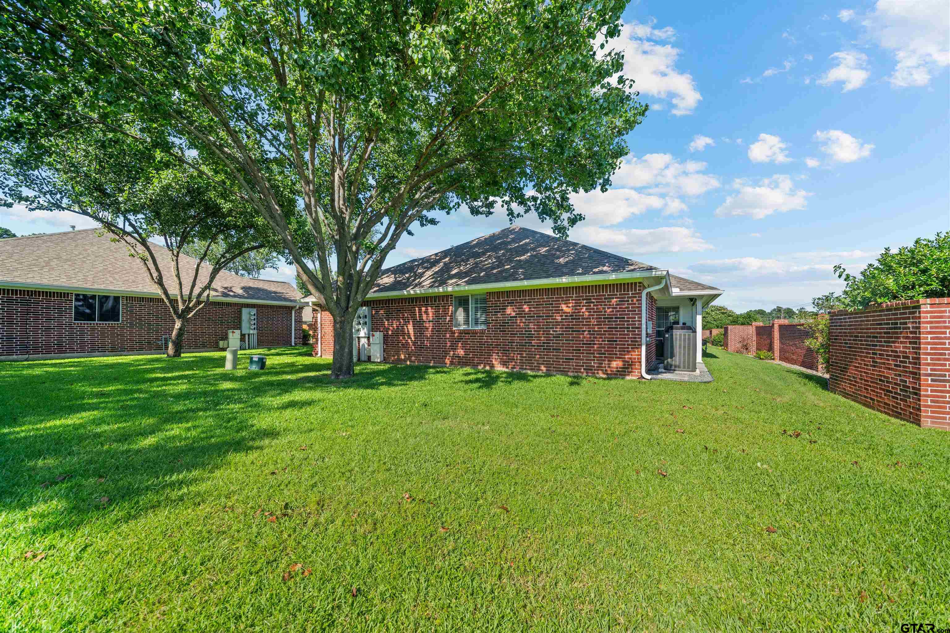 1521 Rice Road, Unit A105 Tyler, TX 75703 - Photo 3 of 28 a front view of a house with a yard