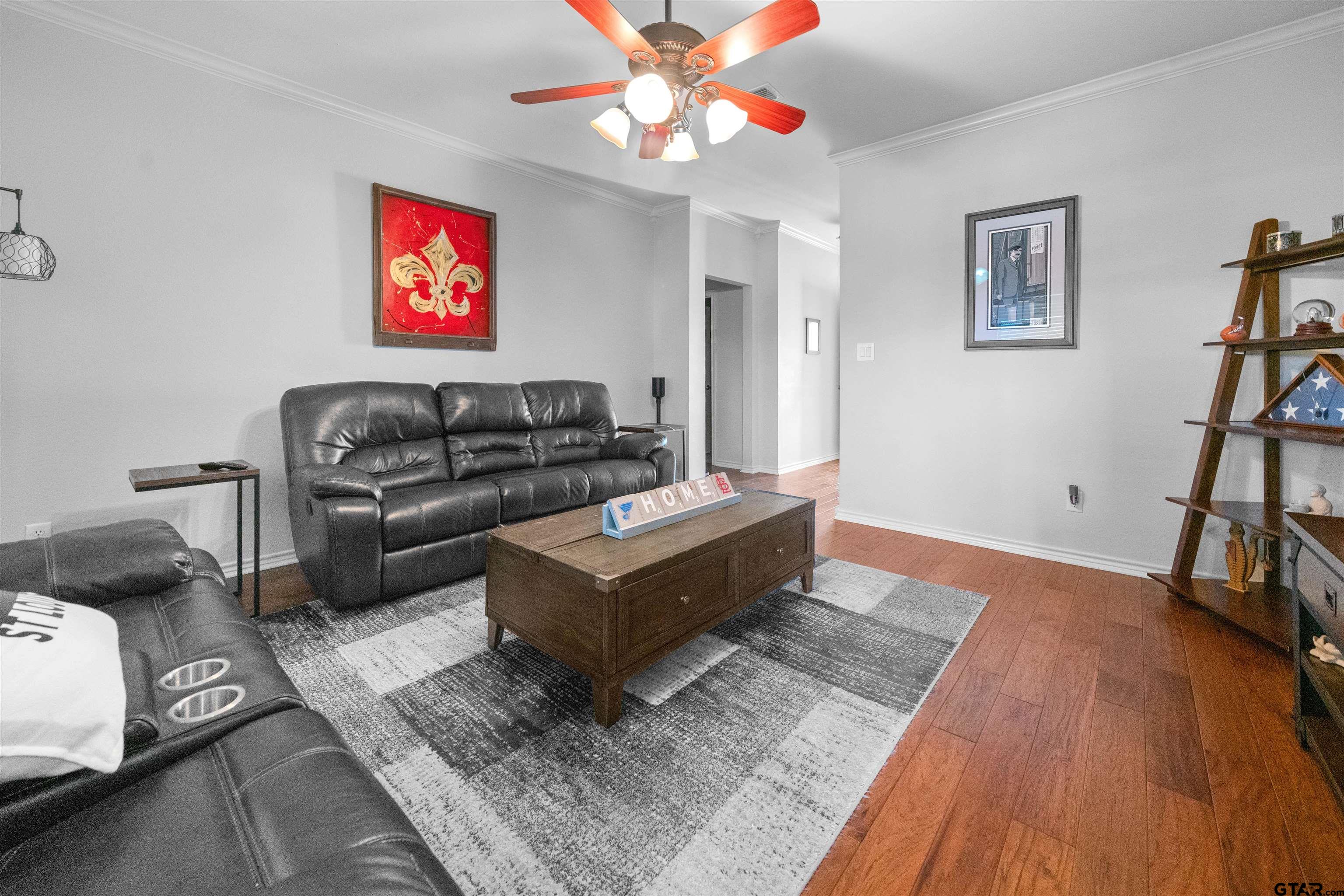 1521 Rice Road, Unit A105 Tyler, TX 75703 - Photo 7 of 28 a living room with furniture and a wooden floor