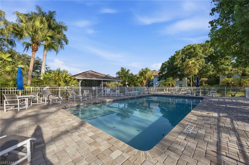 5737 Whitaker Road, Unit C101 Naples, FL 34112 - Photo 24 of 28 a view of swimming pool with outdoor seating and plants