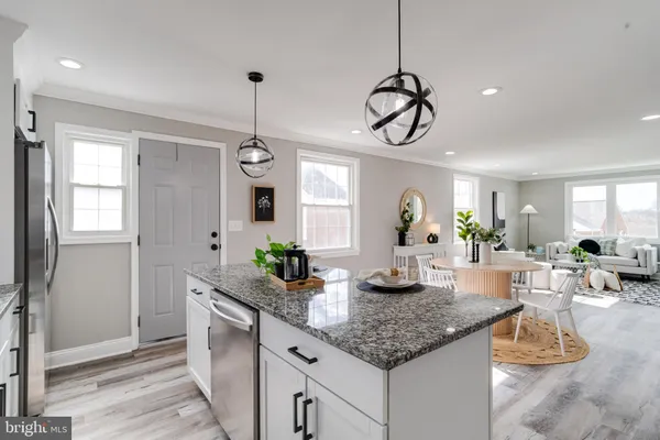 a kitchen with kitchen island granite countertop a counter space dining table and chairs