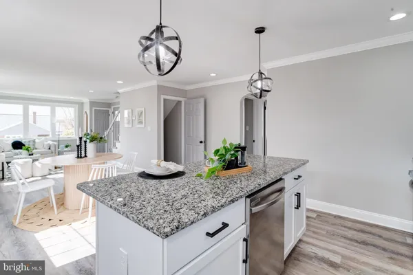 a kitchen with granite countertop kitchen island stainless steel appliances a sink and a counter top space