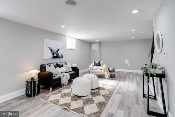 a living room with lots of furniture and a large mirror