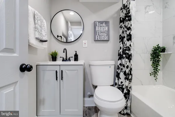 a bathroom with a toilet a sink and a mirror