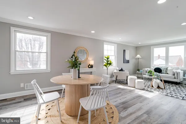 a view of a dining room with furniture window and wooden floor