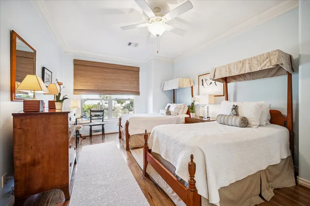 a bedroom with double bed and a chandelier