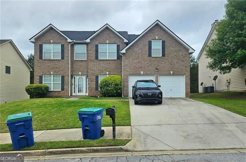 a front view of a house with a yard