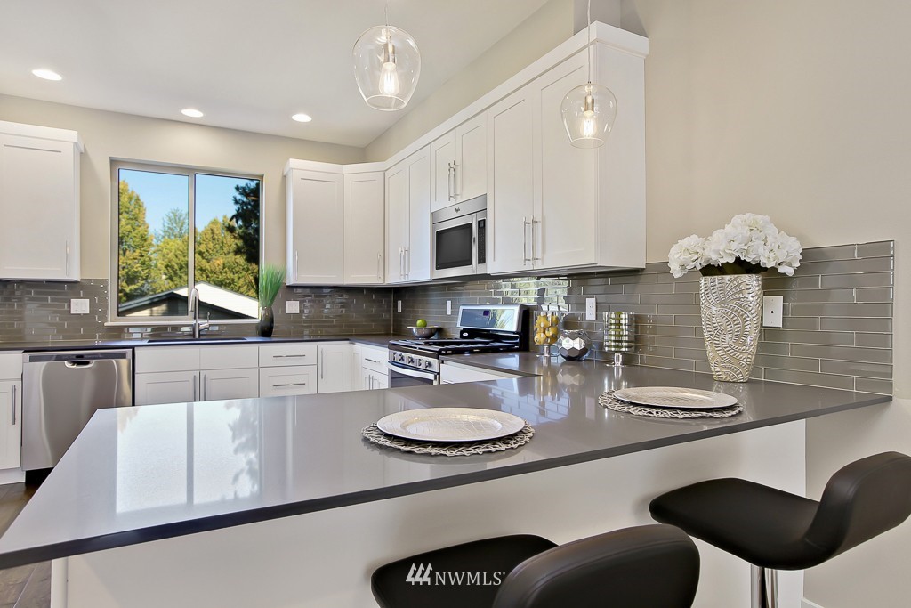 315 South 47th Street Renton, WA 98055 - Photo 3 of 22 a kitchen with stainless steel appliances granite countertop a sink and a stove
