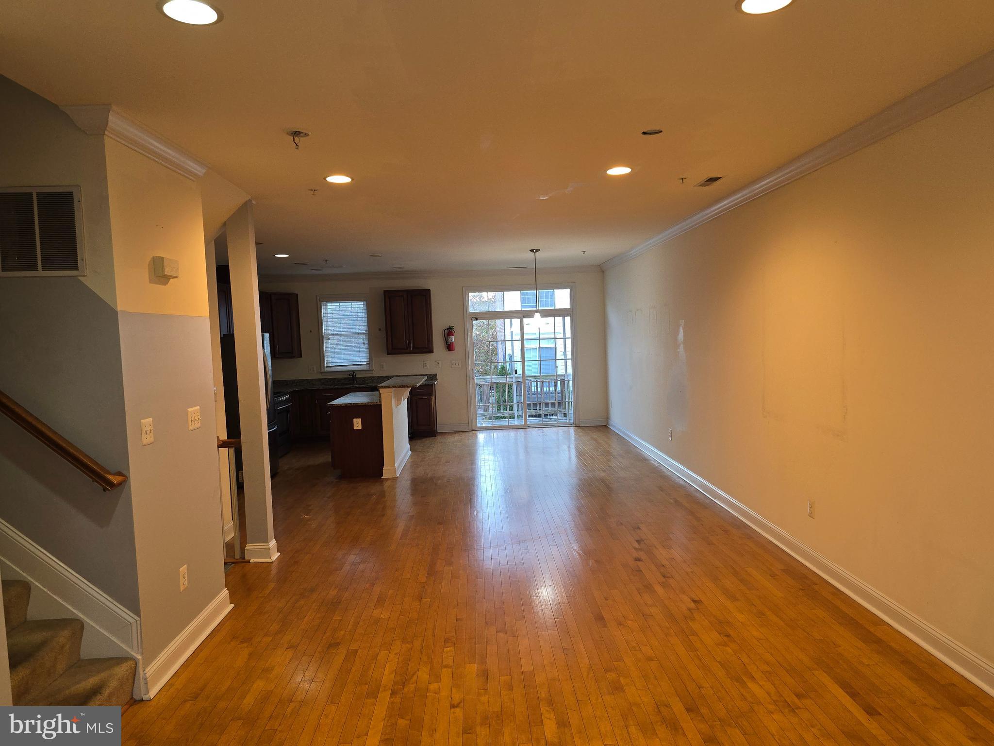 829 McHenry Street Baltimore, MD 21230 - Photo 5 of 17 a view of a living room with kitchen view and wooden floor
