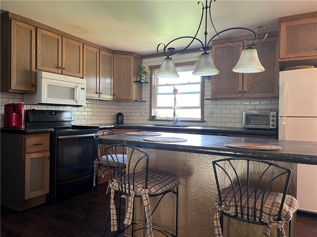 97 Rinkus Drive Indiana, PA 15701 - Photo 46 of 48 a kitchen with stainless steel appliances granite countertop a sink a stove a table and chairs
