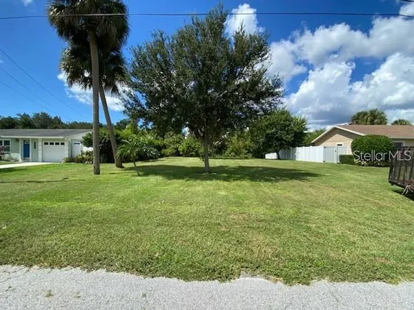a view of a house with a big yard and potted plants
