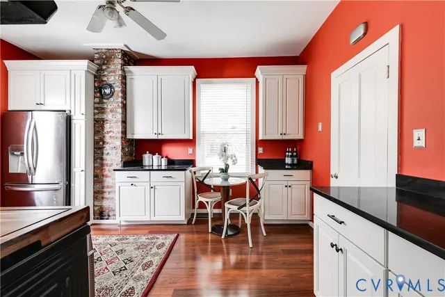 a kitchen with a refrigerator and a stove top oven