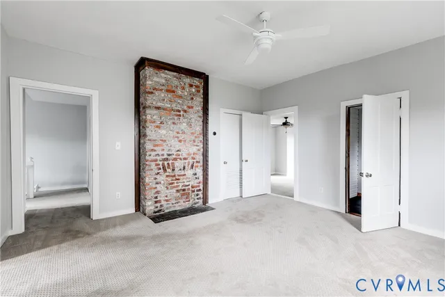 an empty room with windows and closet