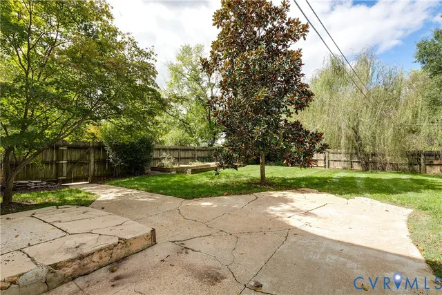 a view of a backyard with a tree