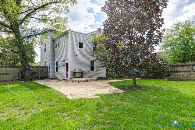 a view of garden with wooden fence