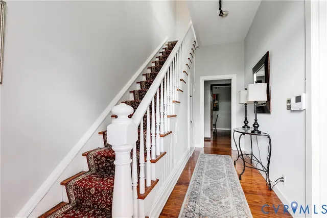 a hallway with furniture and wooden floor