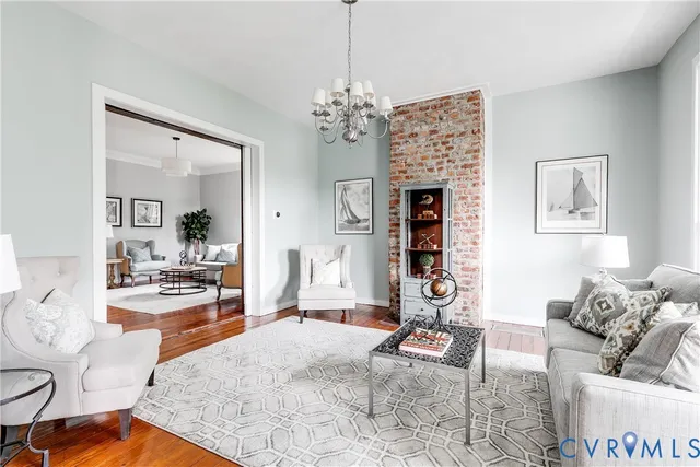 a living room with furniture and a chandelier