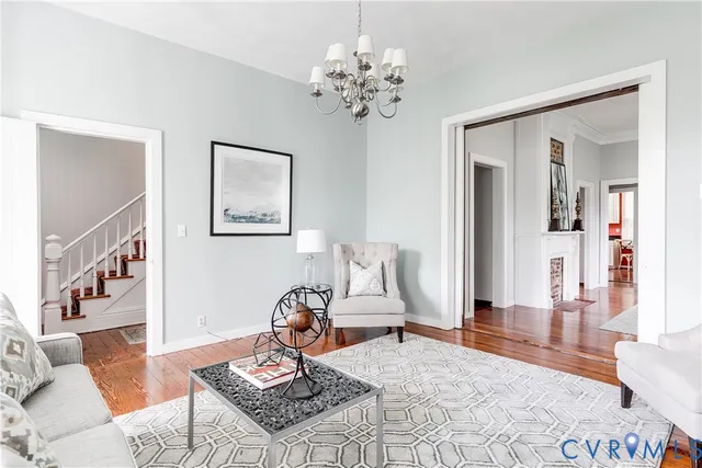 a living room with furniture and wooden floor