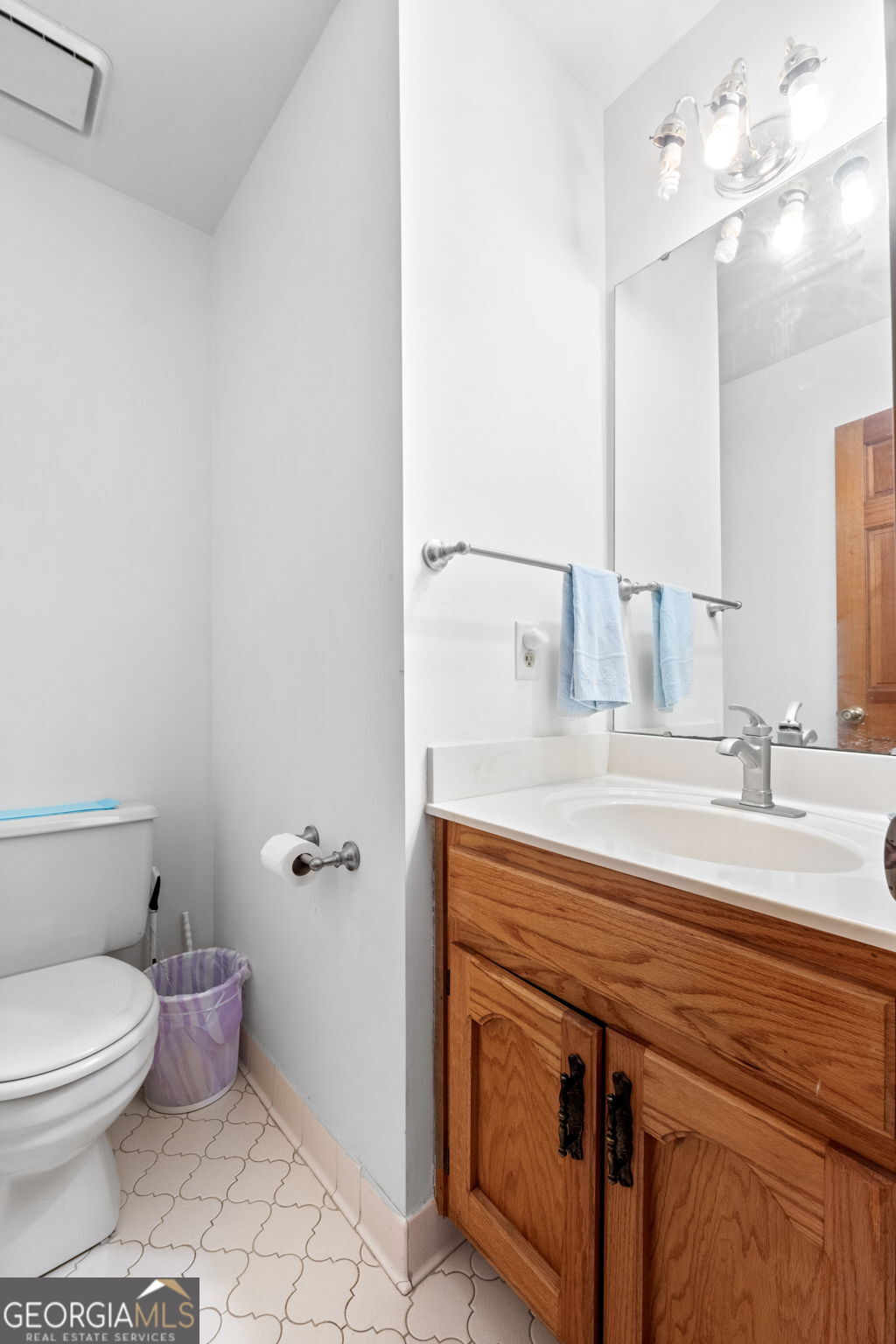 110 The Farm Road McDonough, GA 30252 - Photo 12 of 32 a bathroom with a granite countertop toilet sink and mirror
