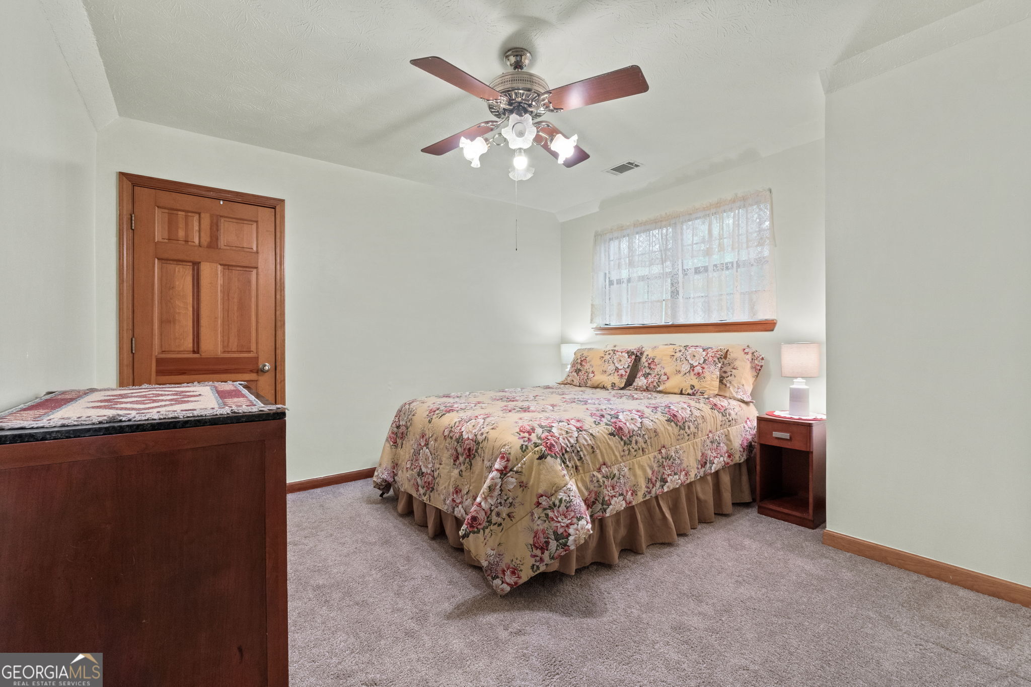 110 The Farm Road McDonough, GA 30252 - Photo 21 of 32 a spacious bedroom with a bed and a chandelier