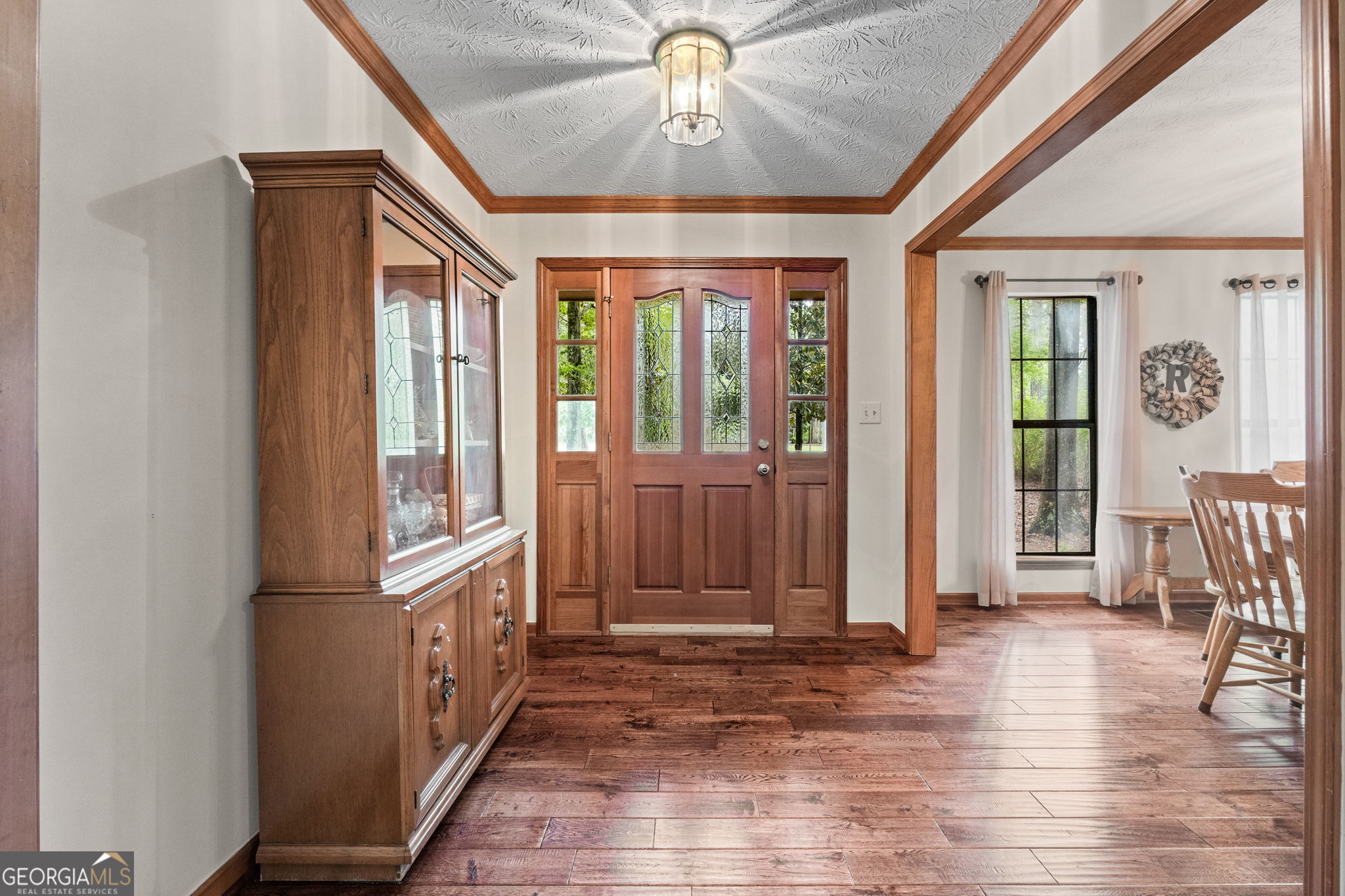 110 The Farm Road McDonough, GA 30252 - Photo 3 of 32 a view of a hallway with wooden floor and windows