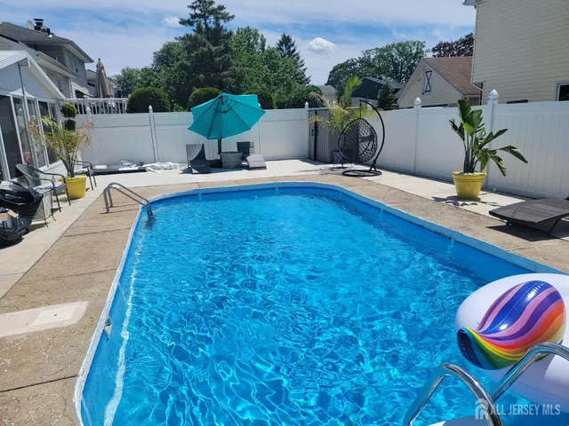 a backyard of a house with barbeque oven