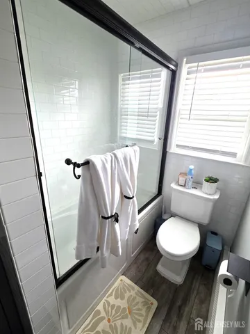 a bathroom with a toilet sink and a mirror