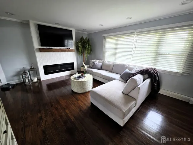 a living room with furniture fireplace and a flat screen tv