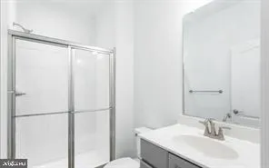 a bathroom with a sink toilet and shower