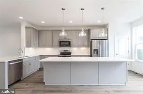 a kitchen with stainless steel appliances granite countertop a sink a stove and a window