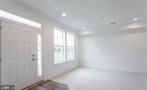 an empty room with windows and closet