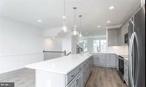 a large kitchen with kitchen island a sink stainless steel appliances and cabinets
