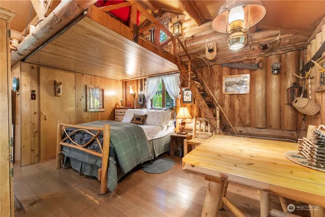 a spacious bedroom with a bed and a chandelier