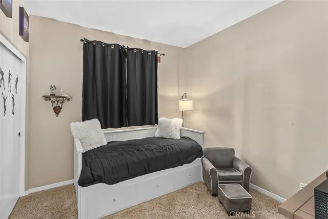 a bedroom with a bed and a chair