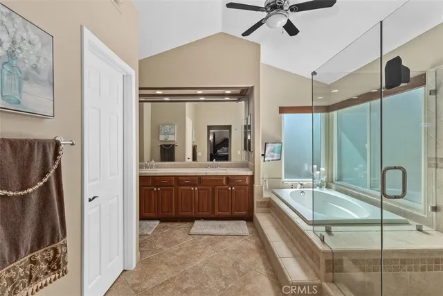 a bathroom with a tub sink and mirror